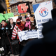 A man holds a flower as members of the Korean American Association and others hold a rally and news conference near the building where Christina Yuna Lee was murdered in the early hours of February 13, 2022, after she was followed home, in New York City.